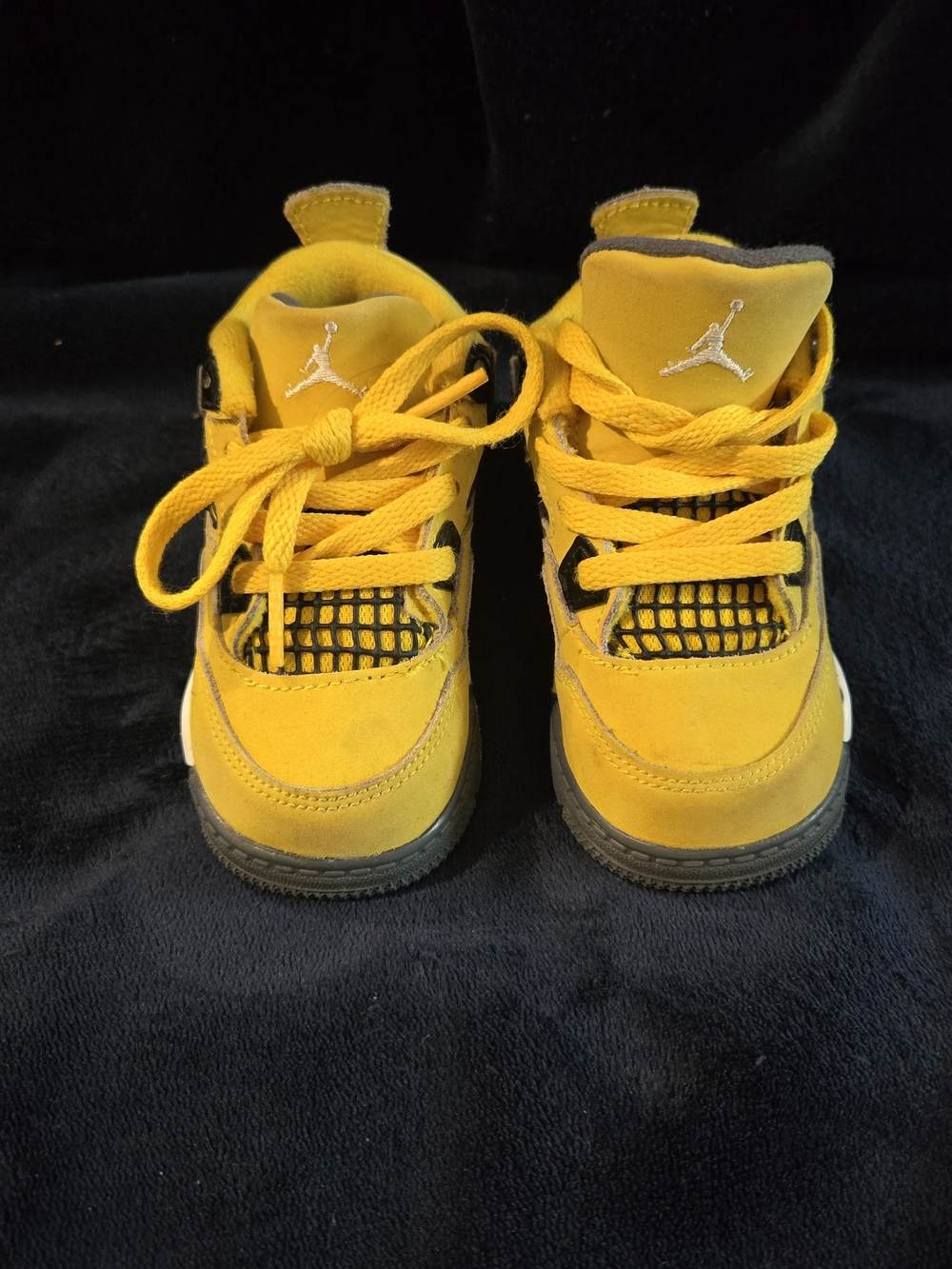 Nike Air Jordan 4 Retro "Lightning" sneaker in the Tour Yellow colorway.